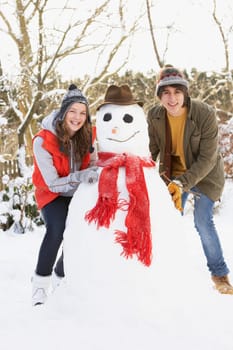 Teenage Couple Building Snowman