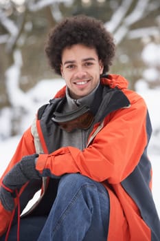Man Wearing Winter Clothes In Snowy Landscape