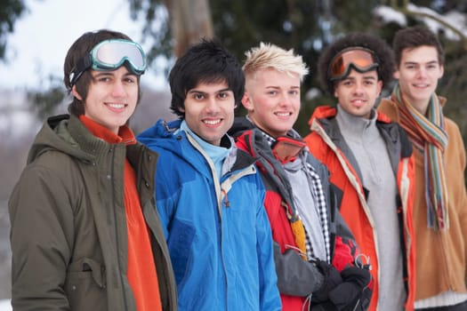 Group Of Teenage Friends In Snowy Winter Landscape