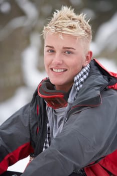Teenage Boy Wearing Winter Clothes In Snowy Landscape