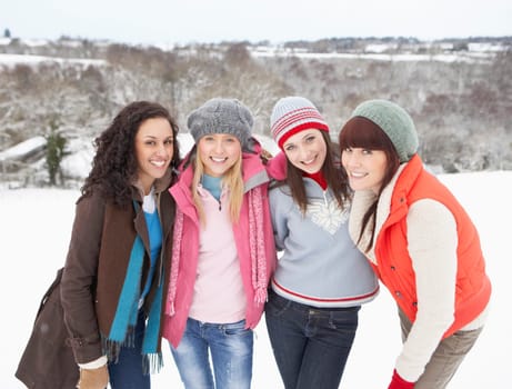 Group Of Female Friends Having Fun In Snowy Landscape