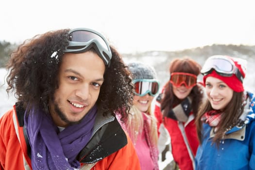 Group Of Teenage Friends Having Fun In Snowy Landscape Wearing Ski Clothing