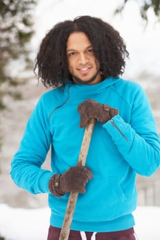 Young Man Clearing Snow From Drive