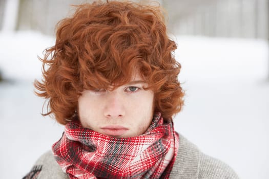 Teenage Boy Wearing Winter Clothes In Snowy Landscape