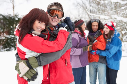 Group Of Teenage Friends Having Fun In Snowy Landscape Wearing Ski Clothing