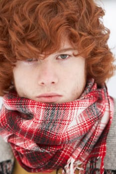 Teenage Boy Wearing Winter Clothes In Snowy Landscape