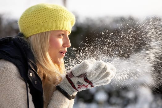 Close Up Of Teenage Girl Wearing Fur Coat In Snowy Landscape