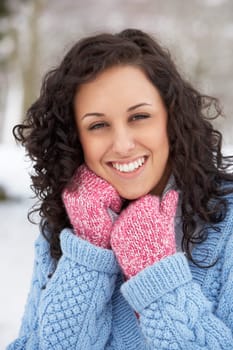 Woman In Snowy Landscape Wearing Warm Clothing