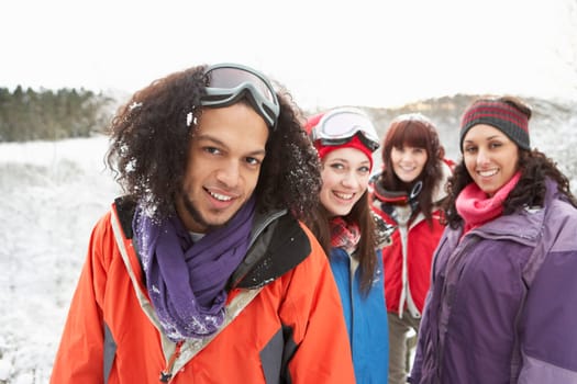 Group Of Teenage Friends Having Fun In Snowy Landscape Wearing Ski Clothing