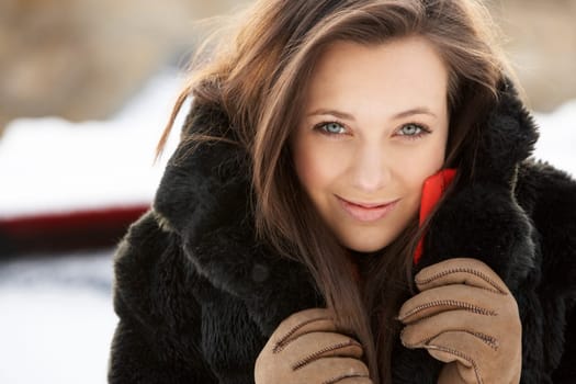 Close Up Of Teenage Girl Wearing Fur Coat In Snowy Landscape