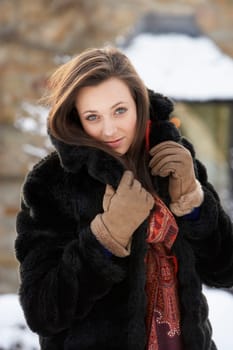 Close Up Of Teenage Girl Wearing Fur Coat In Snowy Landscape