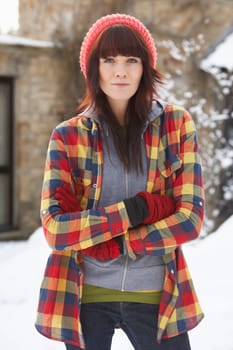 Woman In Snowy Landscape Wearing Warm Clothing
