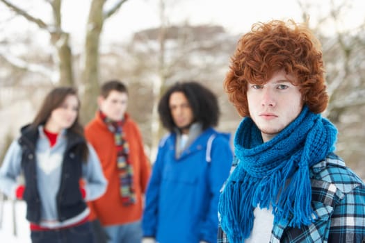 Group Of Teenage Friends Having Fun In Snowy Landscape Wearing Ski Clothing