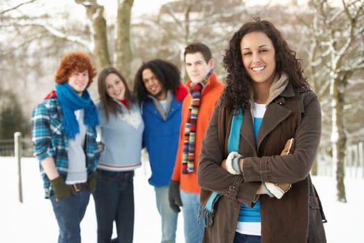 Group Of Teenage Friends Having Fun In Snowy Landscape Wearing Ski Clothing