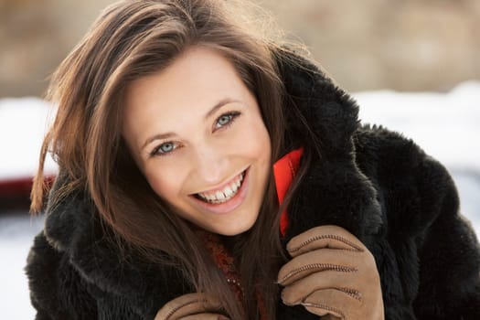Close Up Of Teenage Girl Wearing Fur Coat In Snowy Landscape