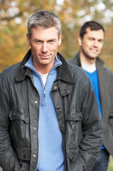 Two Men Standing Outside In Autumn Woodland