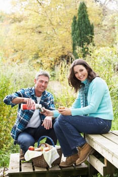 Couple Enjoying Picnic Outdoors In Autumn Woodland
