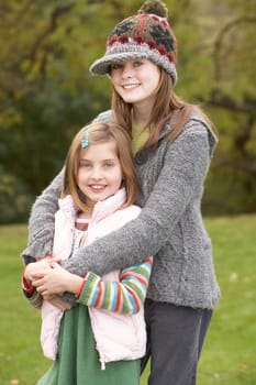 Two Sisters On Walk In Autumn Countryside