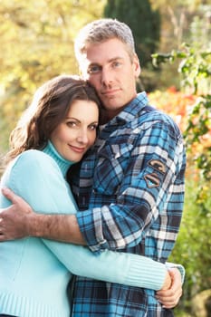 Romantic Couple Embracing By Autumn Woodland