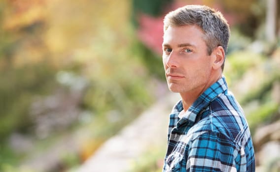 Portrait Of Man Standing Outside In Autumn Landscape