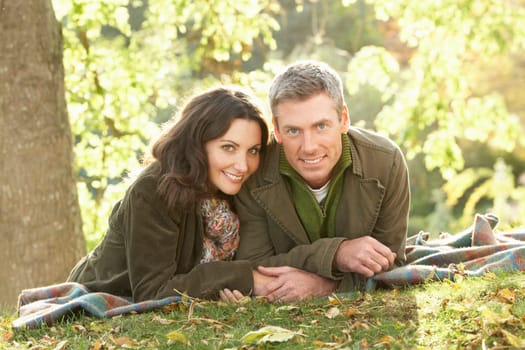 Romantic Couple Relaxing Outdoors In Autumn Landscape