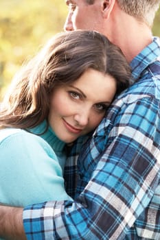 Close Up Of Romantic Couple Embracing By Autumn Woodland