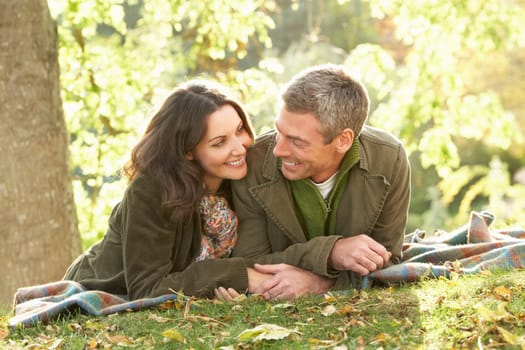 Romantic Couple Relaxing Outdoors In Autumn Landscape
