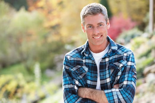 Portrait Of Man Standing Outside In Autumn Landscape