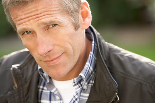 Close Up Portrait Of Man Standing Outside In Autumn Landscape