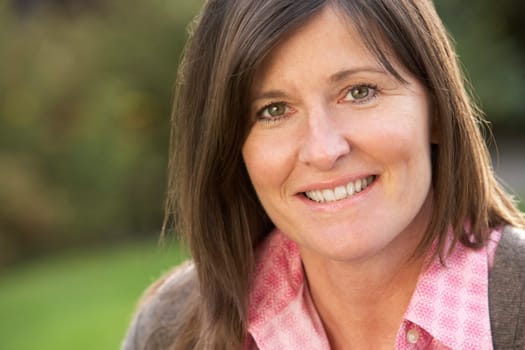 Close Up Portrait Of Smiling Brunette Woman Outdoors