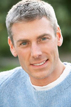 Close Up Portrait Of Man Standing Outside In Autumn Landscape