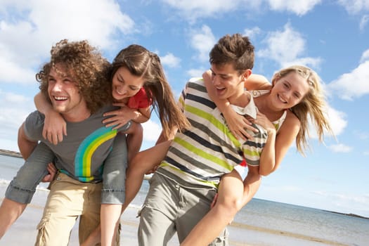 Group Of Young Friends Having Fun On Summer Beach Together
