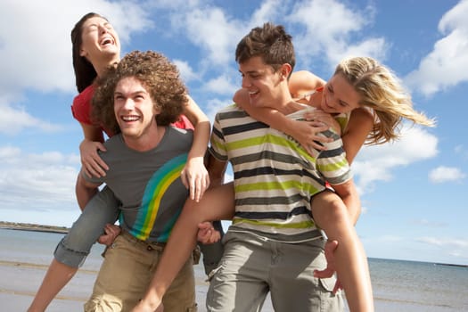 Group Of Young Friends Having Fun On Summer Beach Together