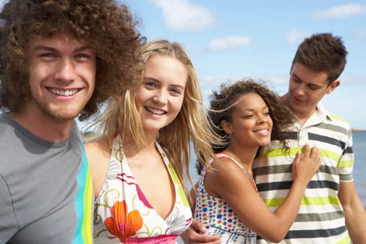 Group Of Young Friends Having Fun On Summer Beach Together