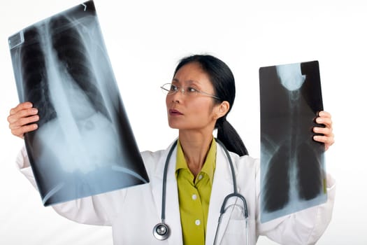 Asian female doctor reviews the results of a chest x-ray. Horizontal shot. Isolated on white.