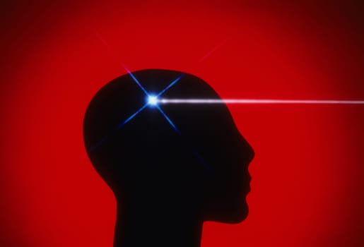 Profile of a mannequin head silhouetted against a red background, with a beam of white light coming from the brain region. Horizontal shot.