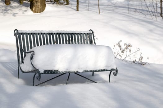 Snow-covered bench in winter, Quebec, Canada