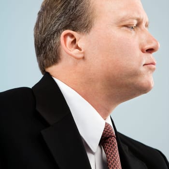 Caucasian middle aged businessman profile portrait.
