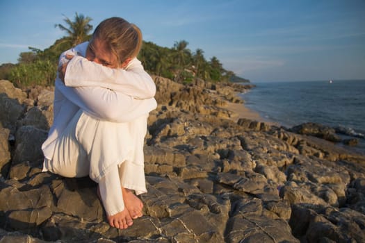 Woman on rocky shoreline