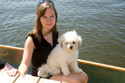 Girl in boat with dog, Lake of the Woods, Ontario, Canada
