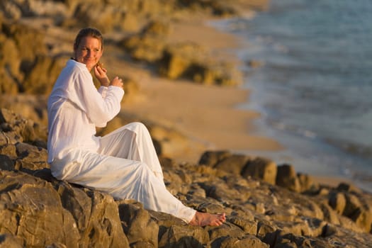 Woman on rocky shoreline