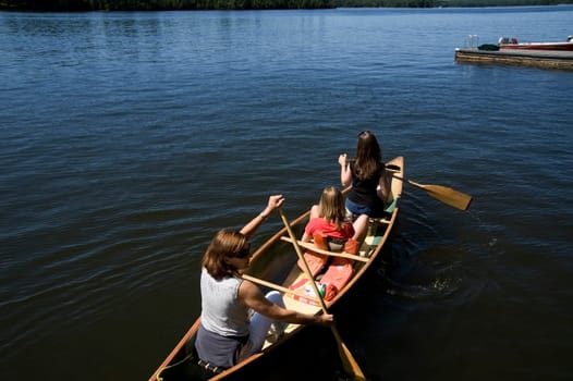 Family canoeing on lake, Lake of the Woods, Ontario, Canada