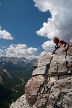 Man sitting on a mountain top enjoying the view