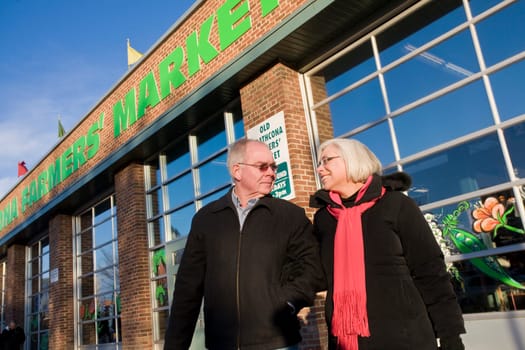 Senior couple outside farmer's market, Old Strathcona, Edmonton, Alberta, Canada