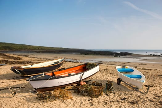 Empty boats on beach, Northumberland, England