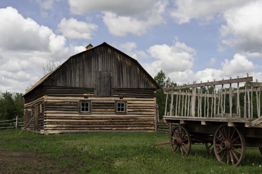 Old fashioned wagon and wood barn