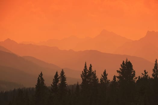 Silhouette of mountain ranges and orange sky