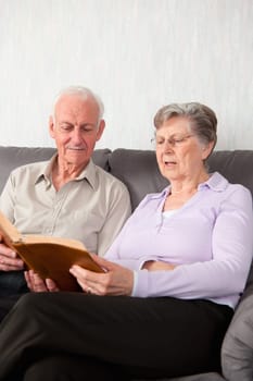 An elderly couple having worship with the Bible