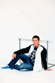 a boy sitting in front of a barrier