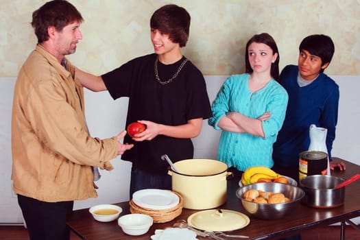 teenagers serving a meal to a man